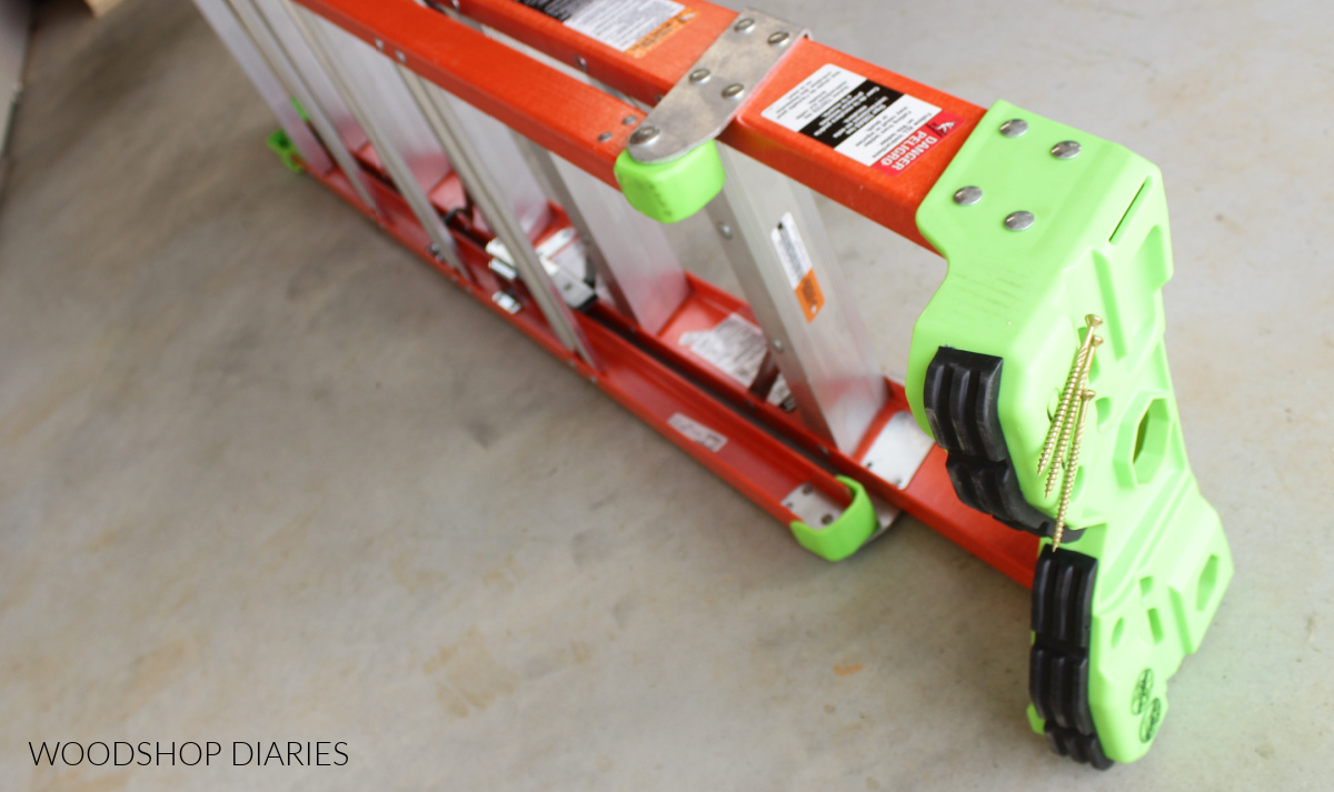 Louisville Ladder laying on it's side on concrete floor showing close up of rubber grips on back side of top section