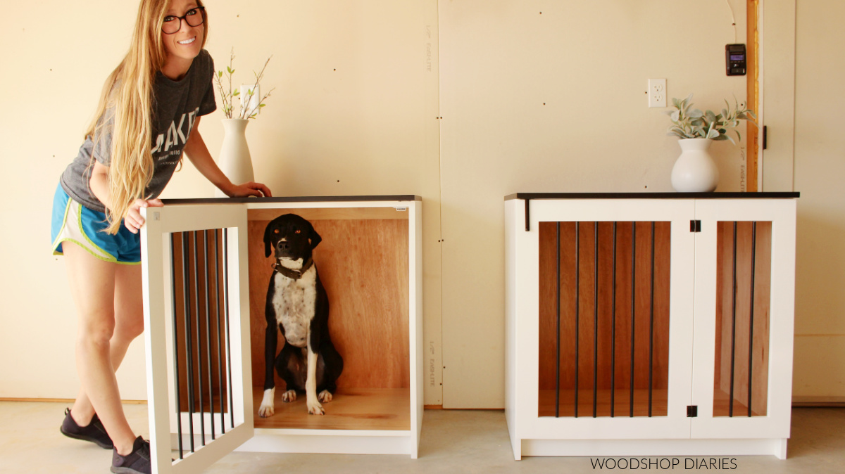 Shara Woodshop Diaries with dog, Lucy, showing finished black and white dog crate with door open