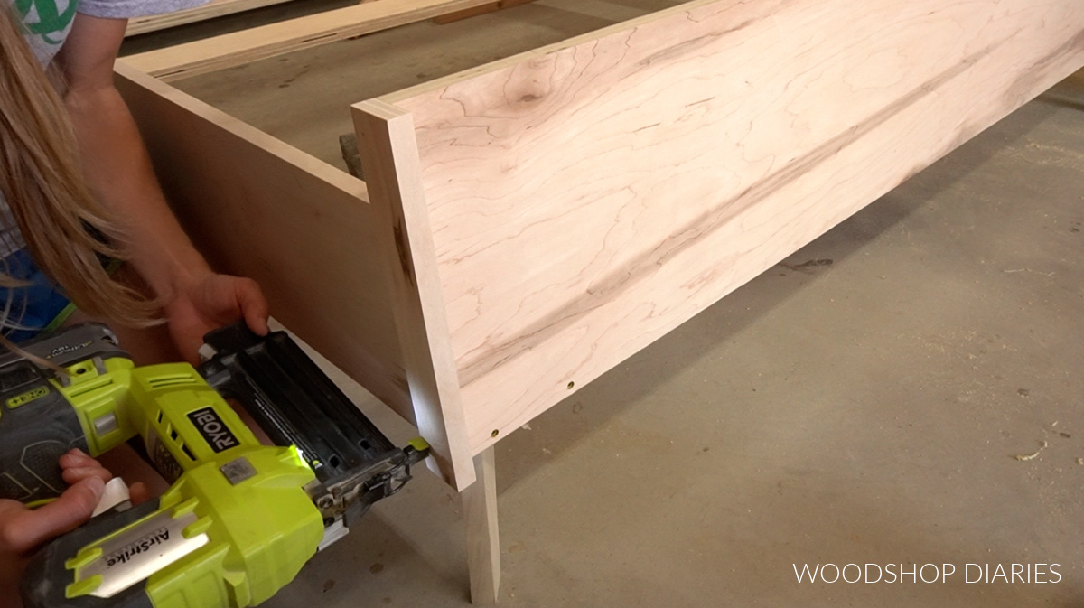 Glue and brad nail trim pieces around footboard