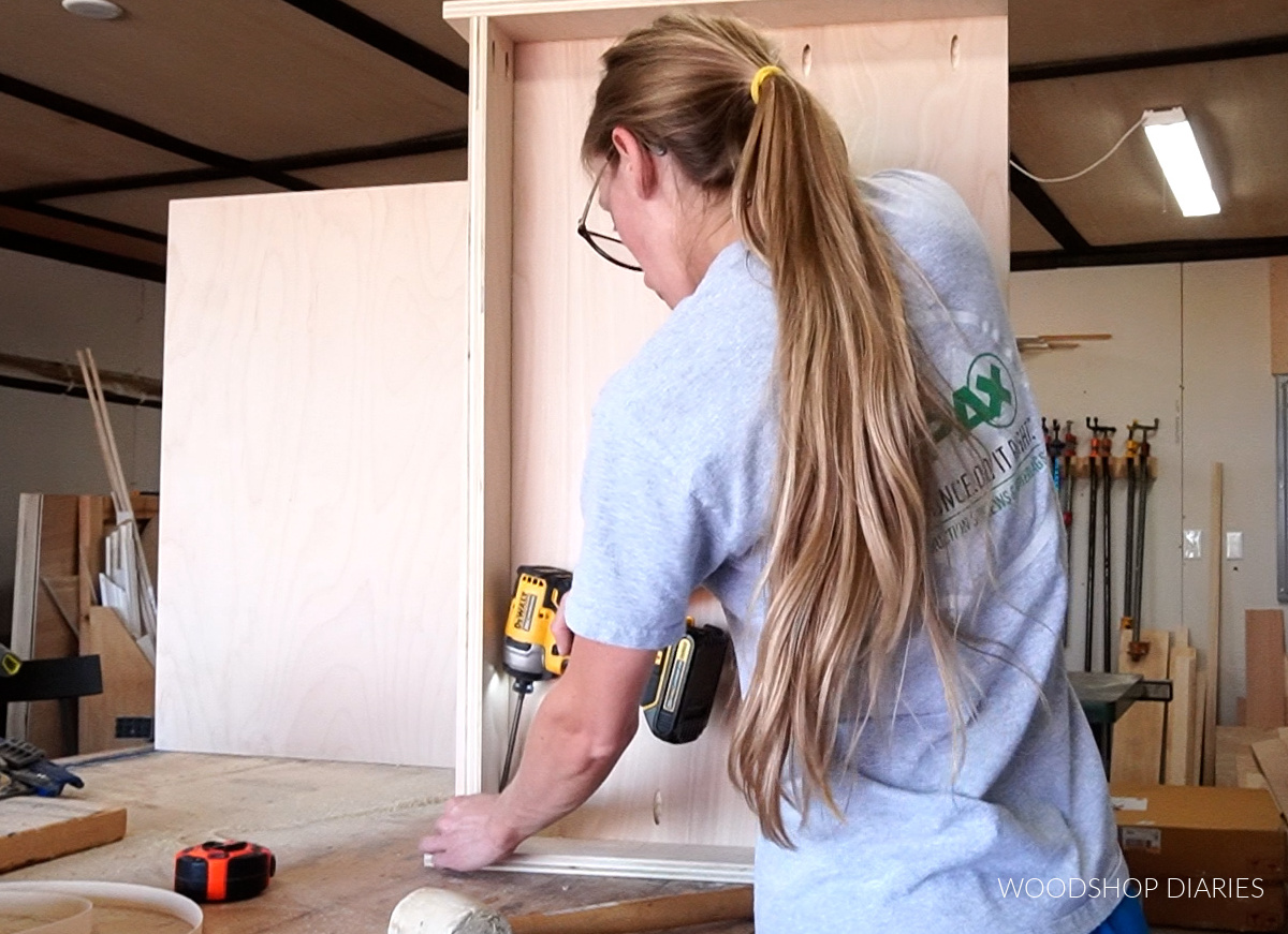 Installing toe kick board into cabinet box