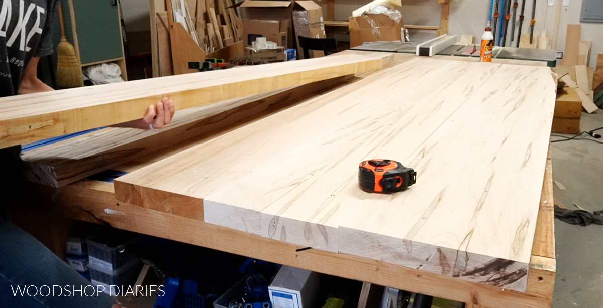 Shara Woodshop Diaries laying out maple wood to arrange boards for table top glue up