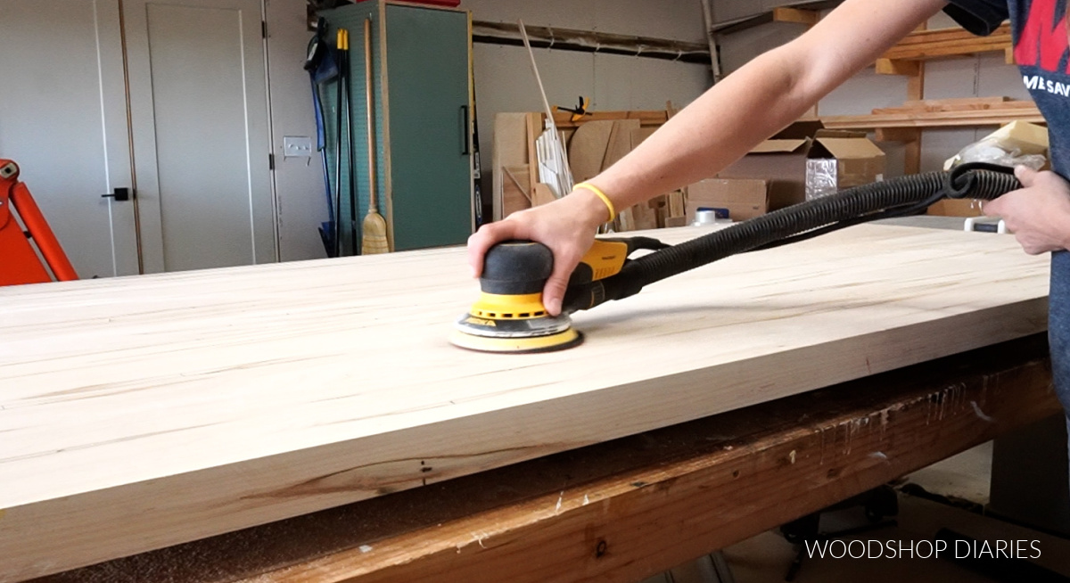 Sanding table top smooth using an orbital sander