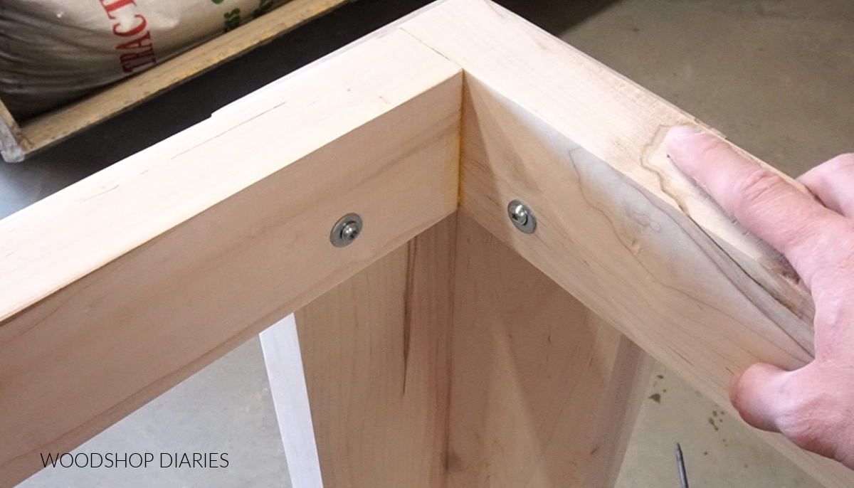 Close up of screws used to assemble table apron to legs at corners