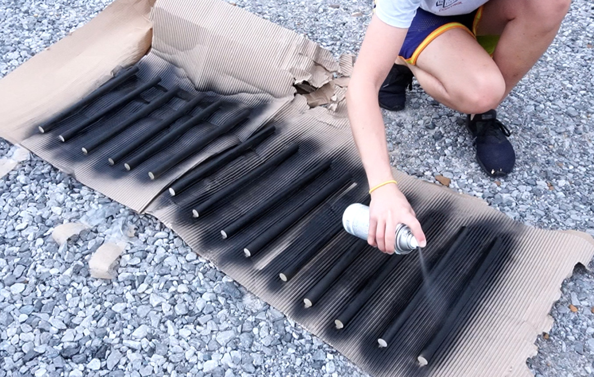 Spray painting dowels to use as outdoor chair rails