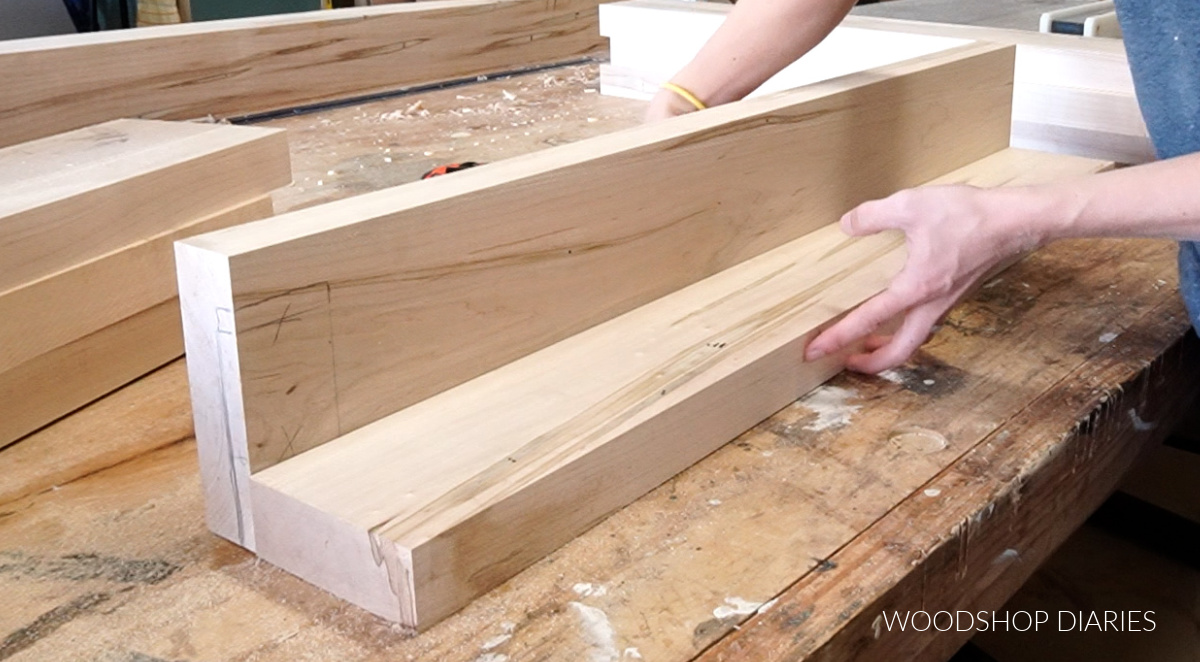 Wood laid out on workbench in L shape to dry fit dining table legs together