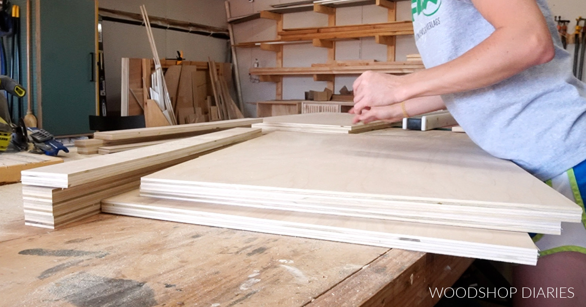 All plywood parts laid out on workbench ready to assemble basic wooden dog crate cabinet