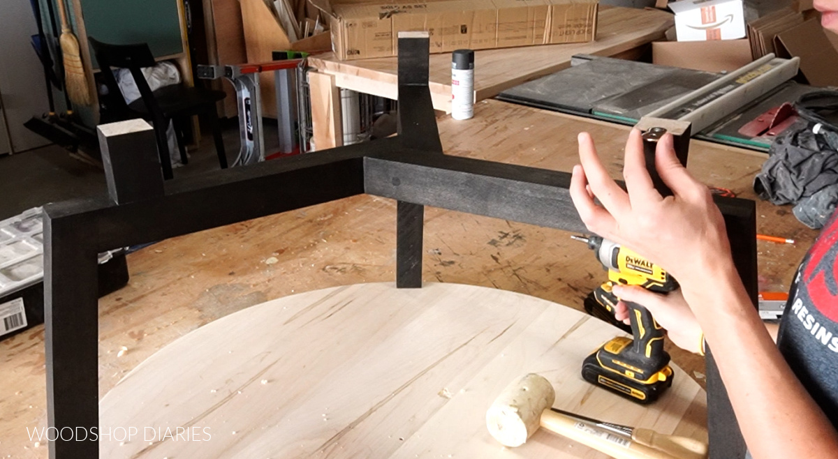 Attaching figure 8 fasteners to risers on round coffee table base