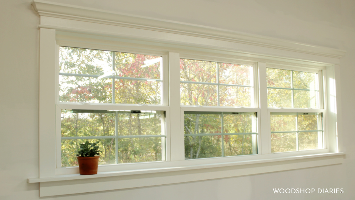 Completely finished window trim painted white with crown molding and half round molding