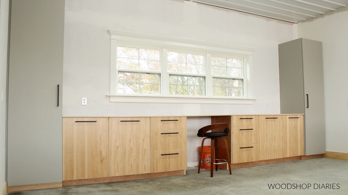 Workshop wall full of pantry and base cabinets made from plywood--tall grey cabinets and hickory base cabinets