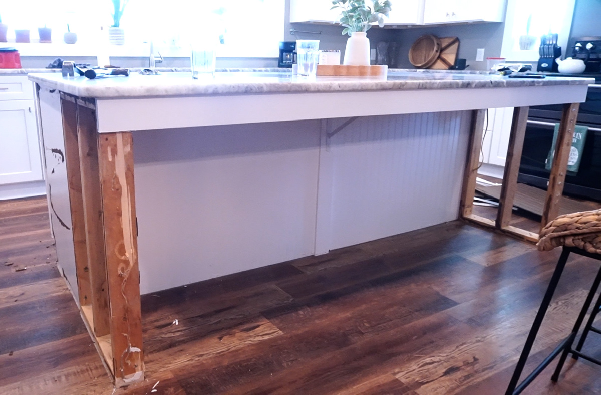 Kitchen island demoed--cabinets and stud framing with granite top still intact