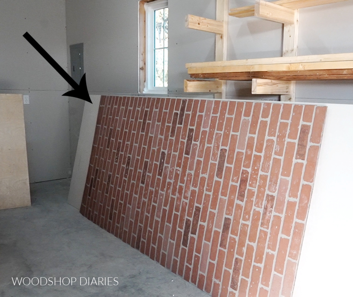 Faux brick paneling leaning against wall in workshop