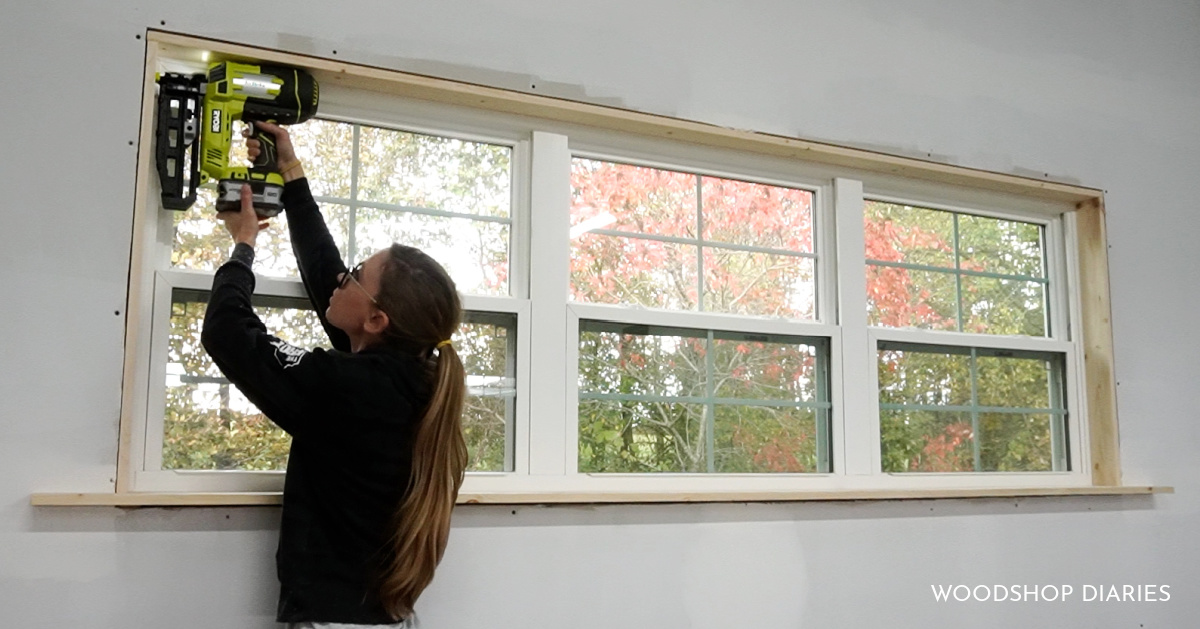 Shara Woodshop Diaries nailing wood to line inside of window frame