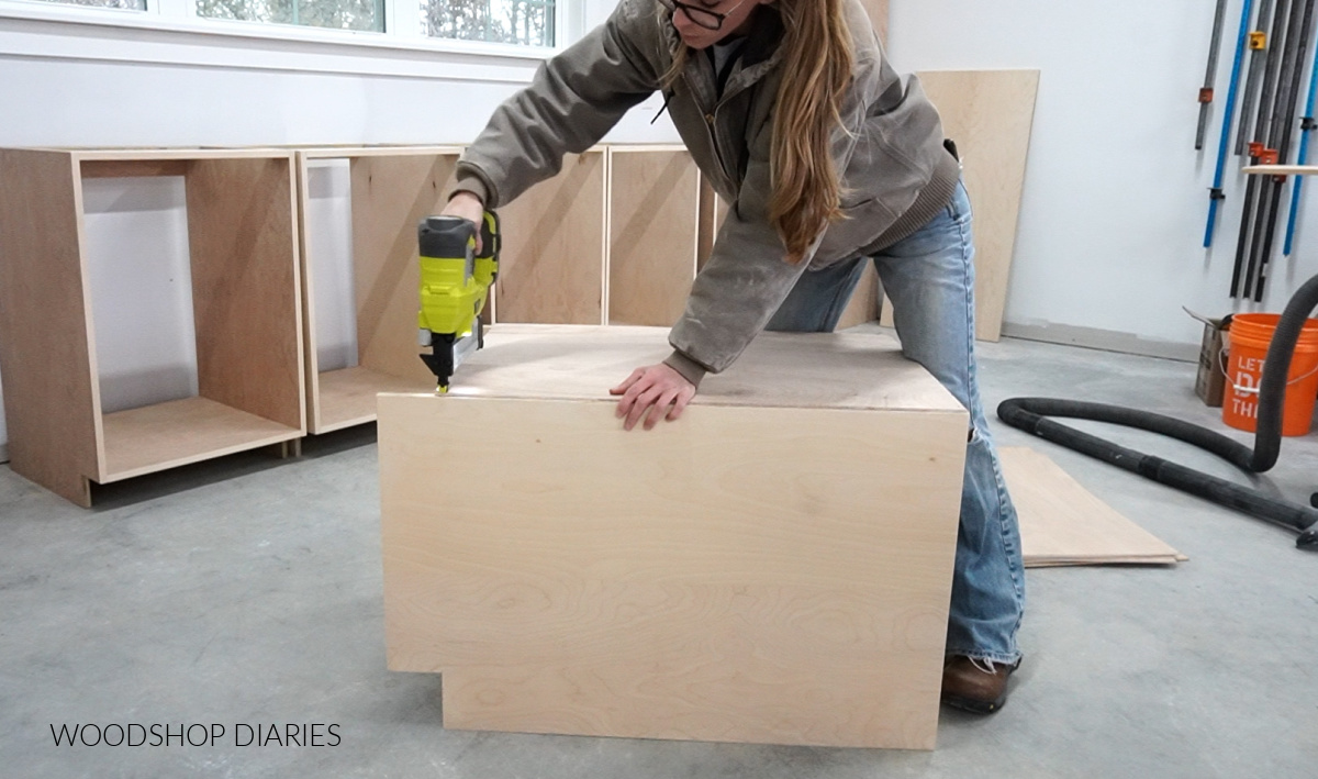 Shara Woodshop Diaries stapling ¼" plywood back onto cabinet box