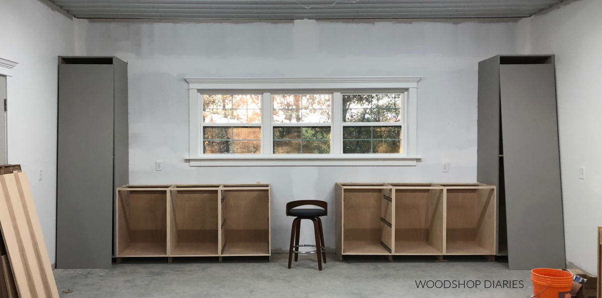 Pantry and base cabinets installed to workshop wall