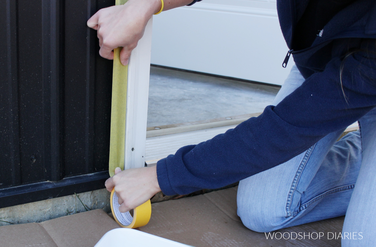 Shara Woodshop Diaries taping off around door before painting