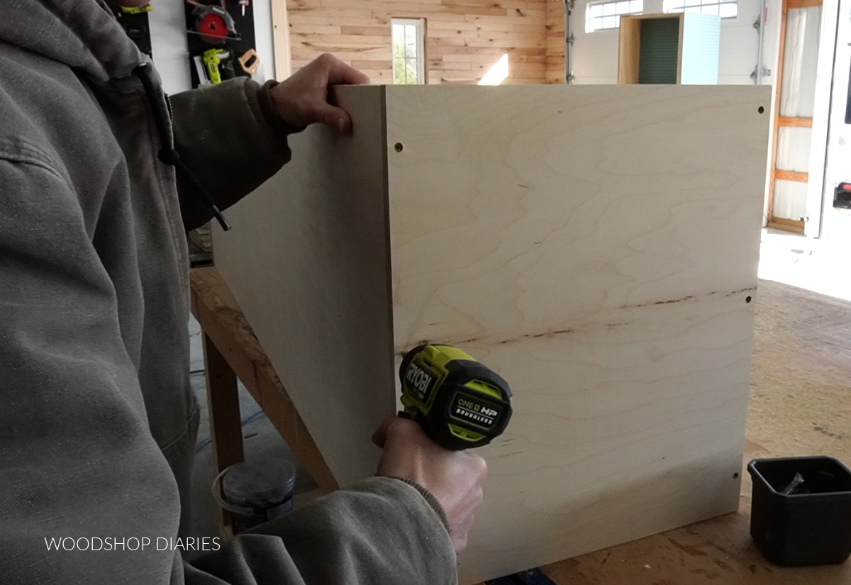 Assembling closet cabinet top cubby boxes on workbench