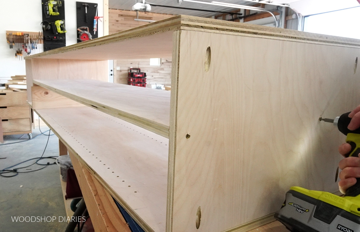 Assembling tall narrow custom closet cabinet with divider panel in top section