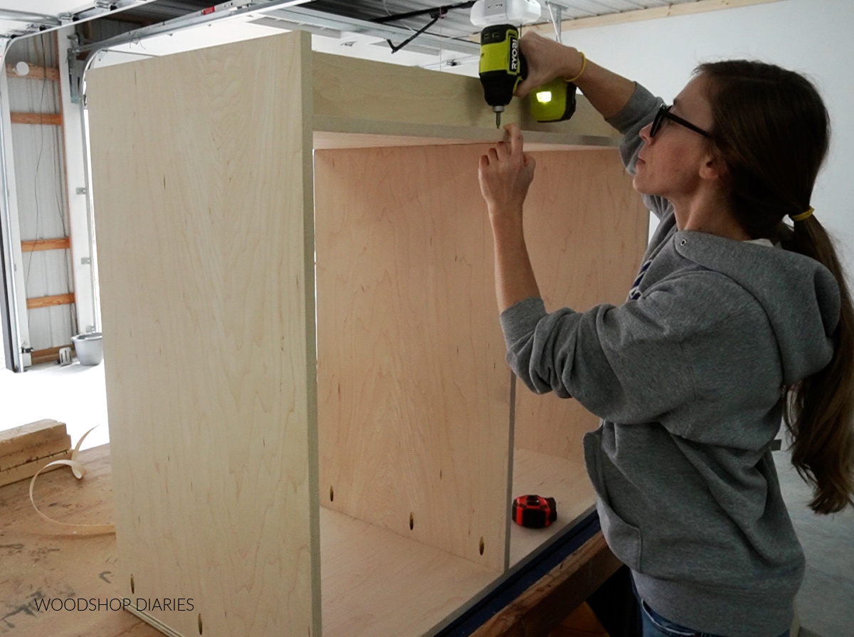 Shara Woodshop Diaries securing middle divider panel into dresser cabinet