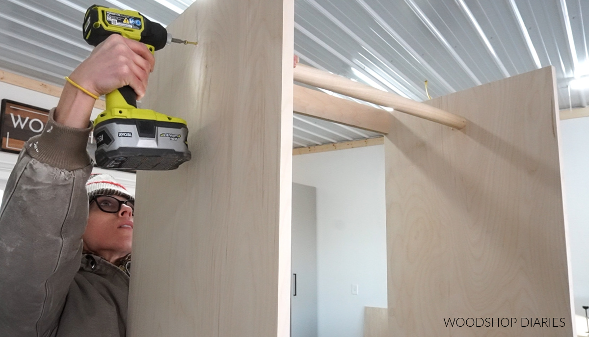 Installing clothes rod using wood screws through cabinet side panels