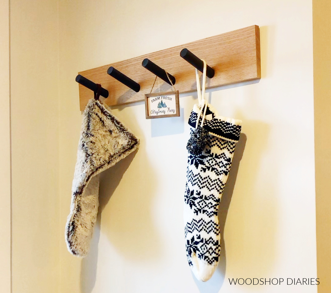 Christmas stockings hanging from pegs on DIY stocking hanger rack