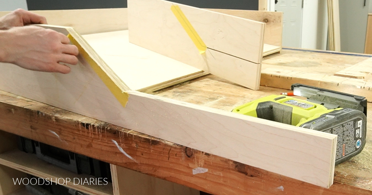 Shara Woodshop Diaries removing tape from plywood on dog bed side panel