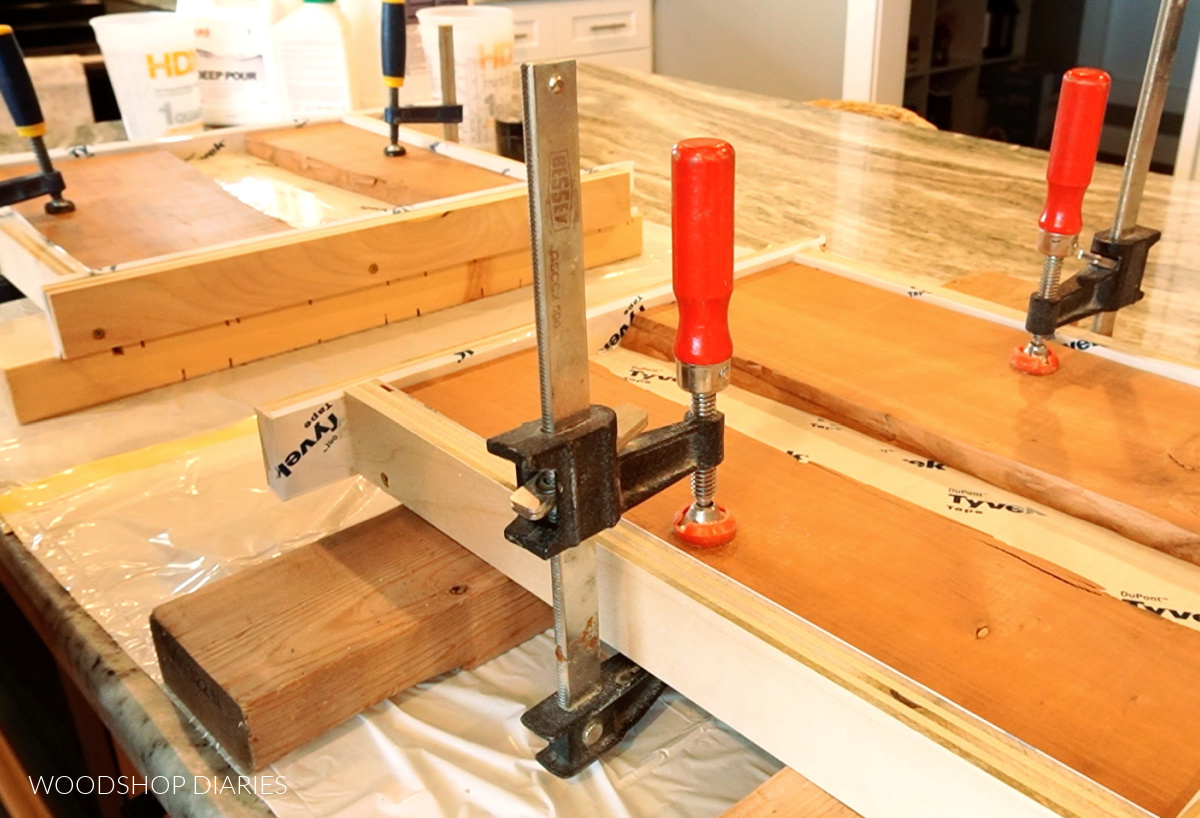 cracked boards clamped in plywood molds ready for epoxy pours