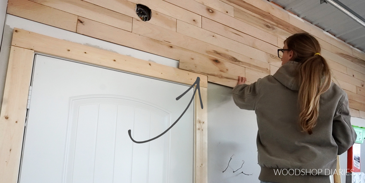 Wall plank board cut to fit around door trim