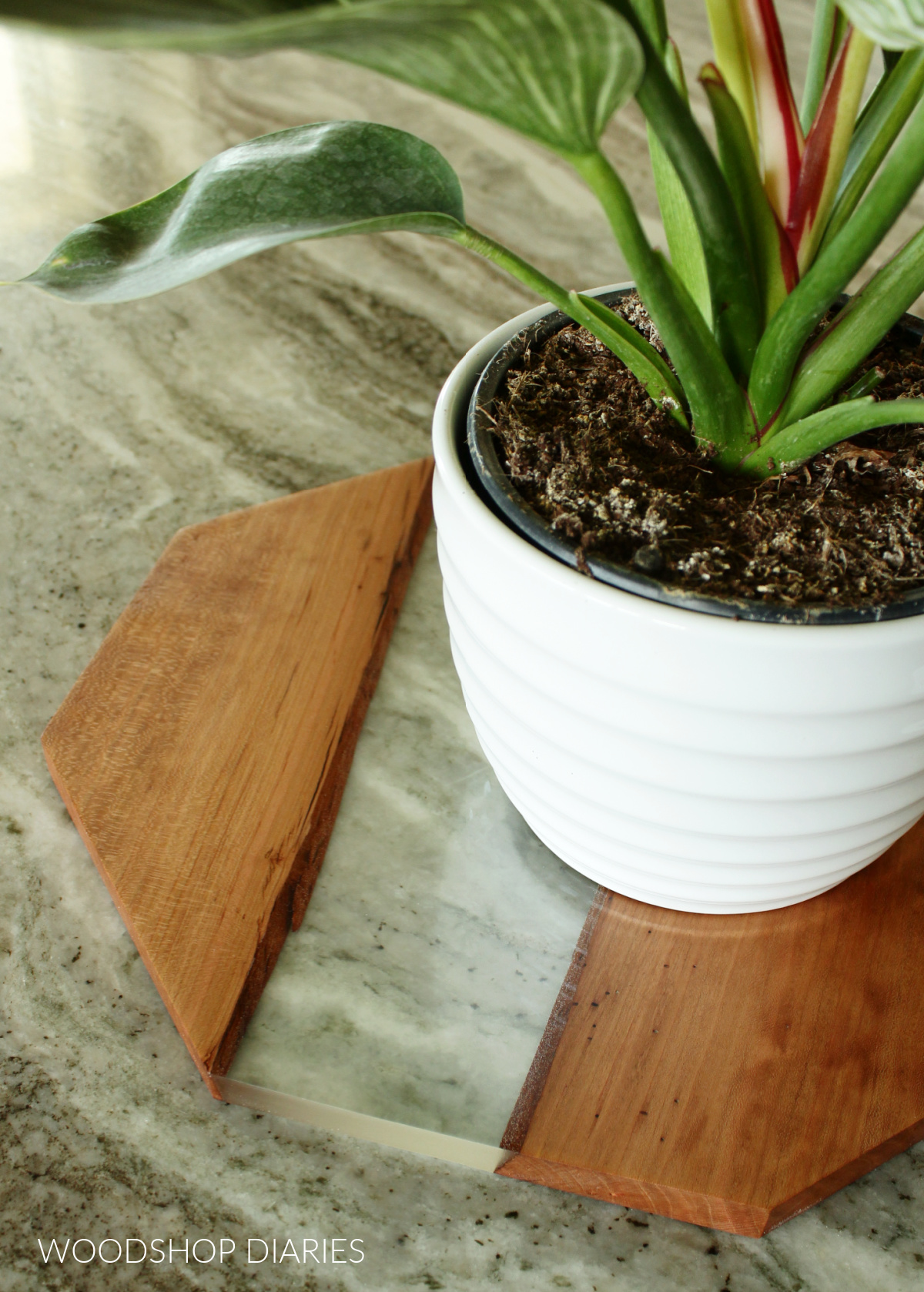 Close up of clear epoxy and wood charger plate project cut in octagon shape