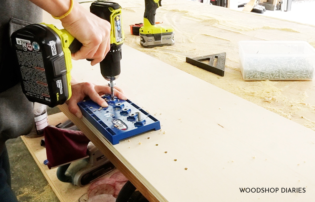 Shara Woodshop Diaries drilling shelf pin holes along bookshelf sides to install adjustable shelves