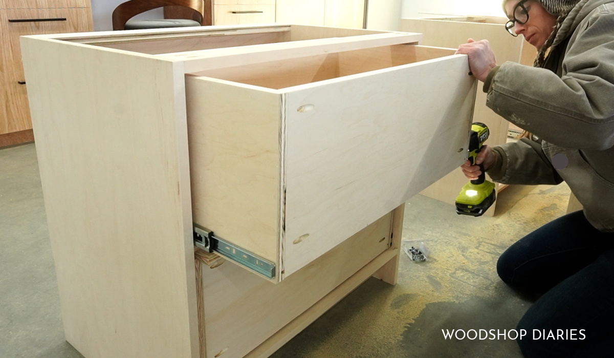 Shara Woodshop Diaries installing drawer boxes onto drawer slides in bookshelf desk cabinets