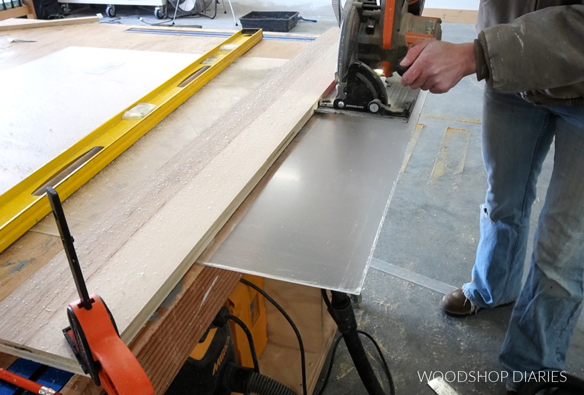 Shara Woodshop Diaries using circular saw to cut down plexiglass sheet