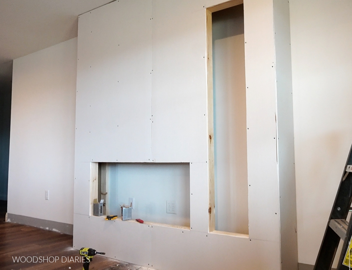 Electric fireplace wall box with drywall installed on front and sides