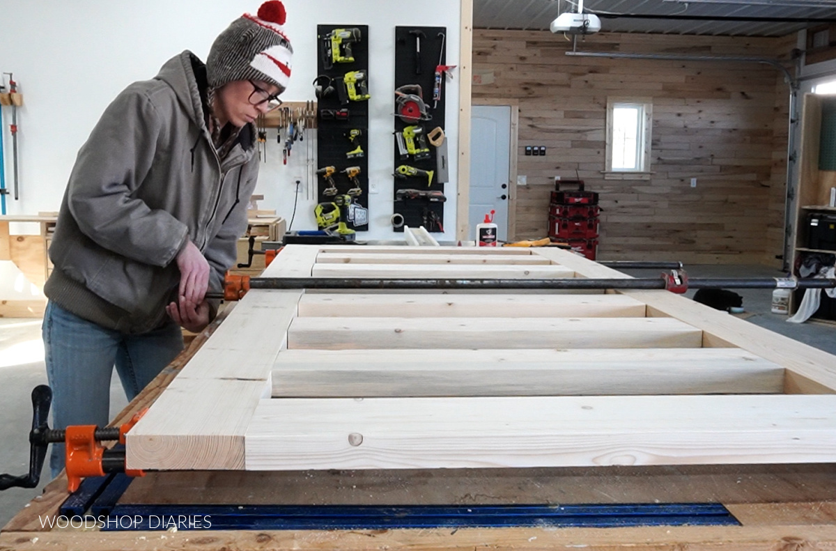 Shara Woodshop Diaries clamping DIY sliding door together in glue up