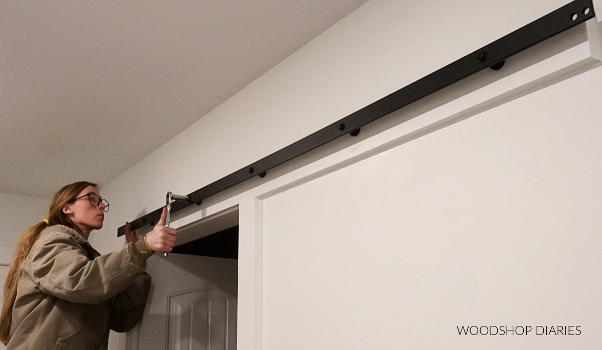 Shara Woodshop Diaries installing sliding door hardware kit onto wall