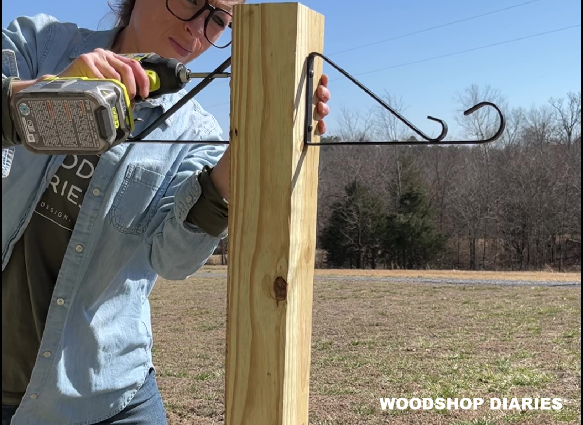 Shara Woodshop Diaries using drill to secure hanging baskets to planter post