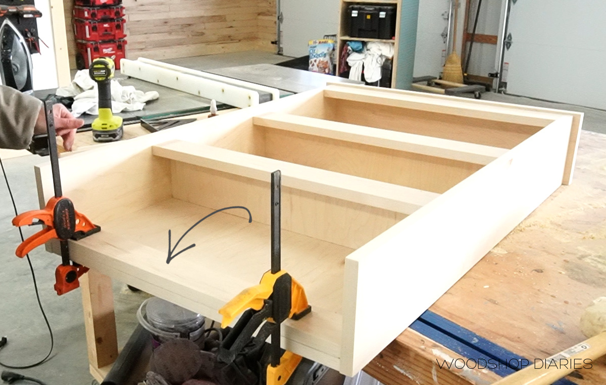 Top trim piece glued and clamped onto top of shelf panel
