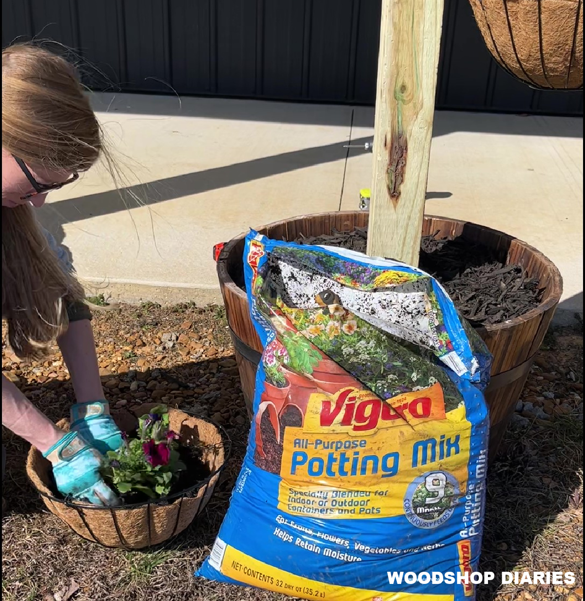 Shara Woodshop Diaries planting flowers in hanging baskets for planter post