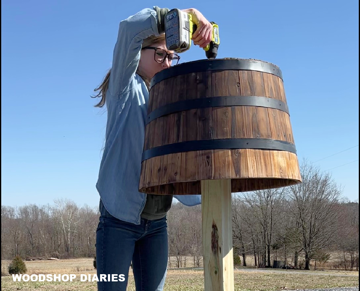 Shara Woodshop Diaries screwing barrel planter onto post