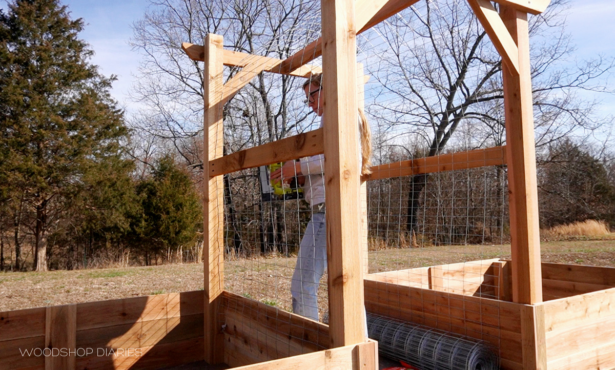 Shara Woodshop Diaries stapling welded wire onto garden arbor