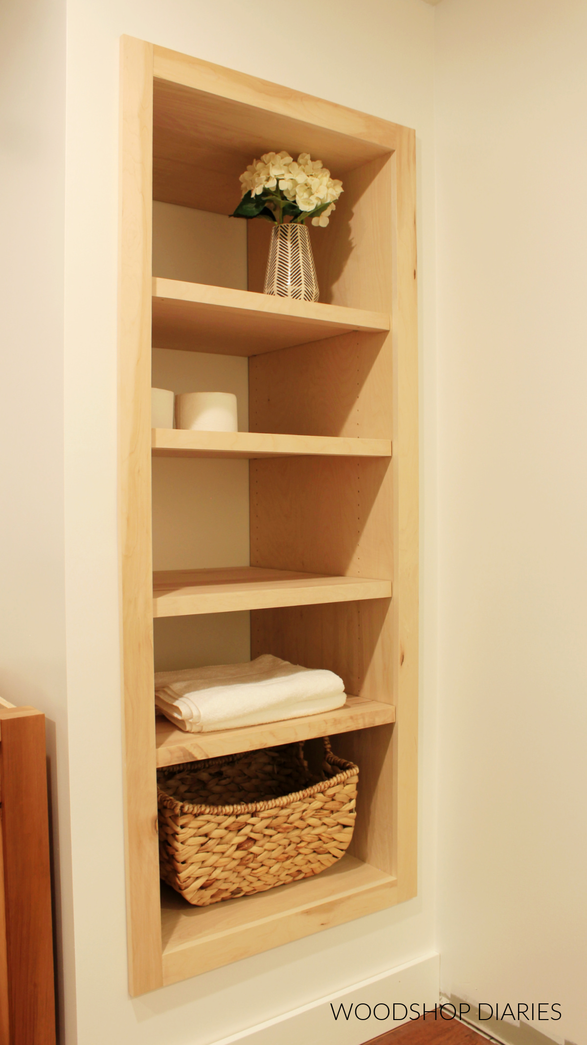 Built in cubby shelf complete with four shelves in bathroom closet opening