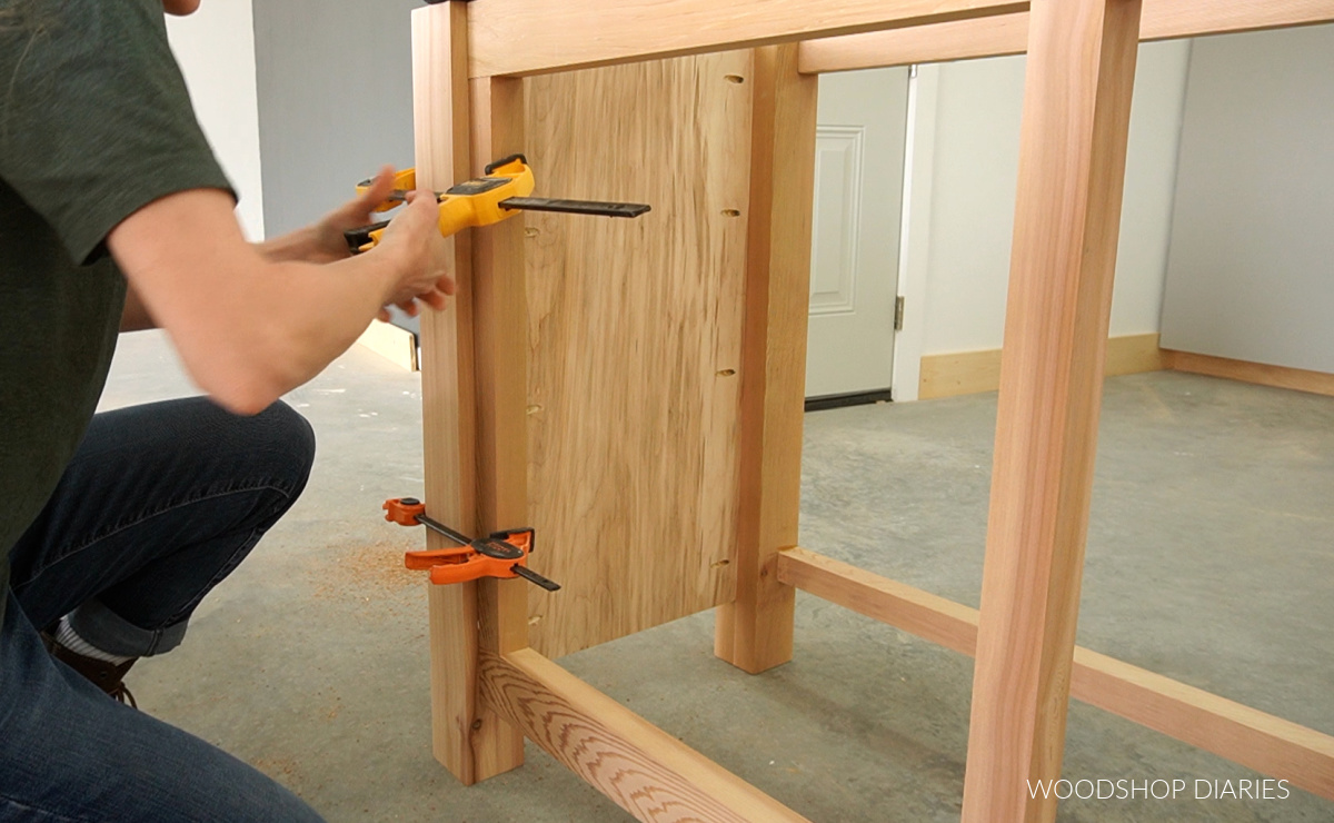 Shara Woodshop Diaries clamping decorative outside trim piece to vanity leg