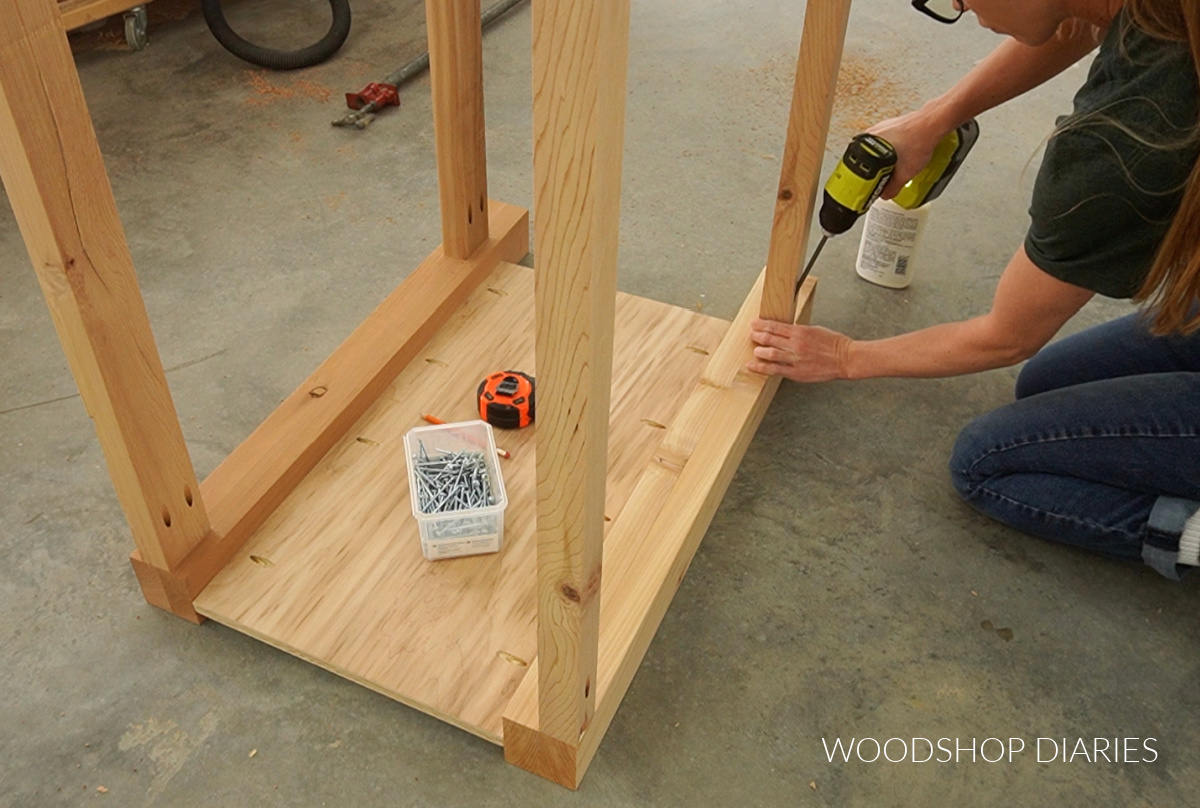 Shara Woodshop Diaries screwing frame pieces into side panels to assemble bathroom vanity frame