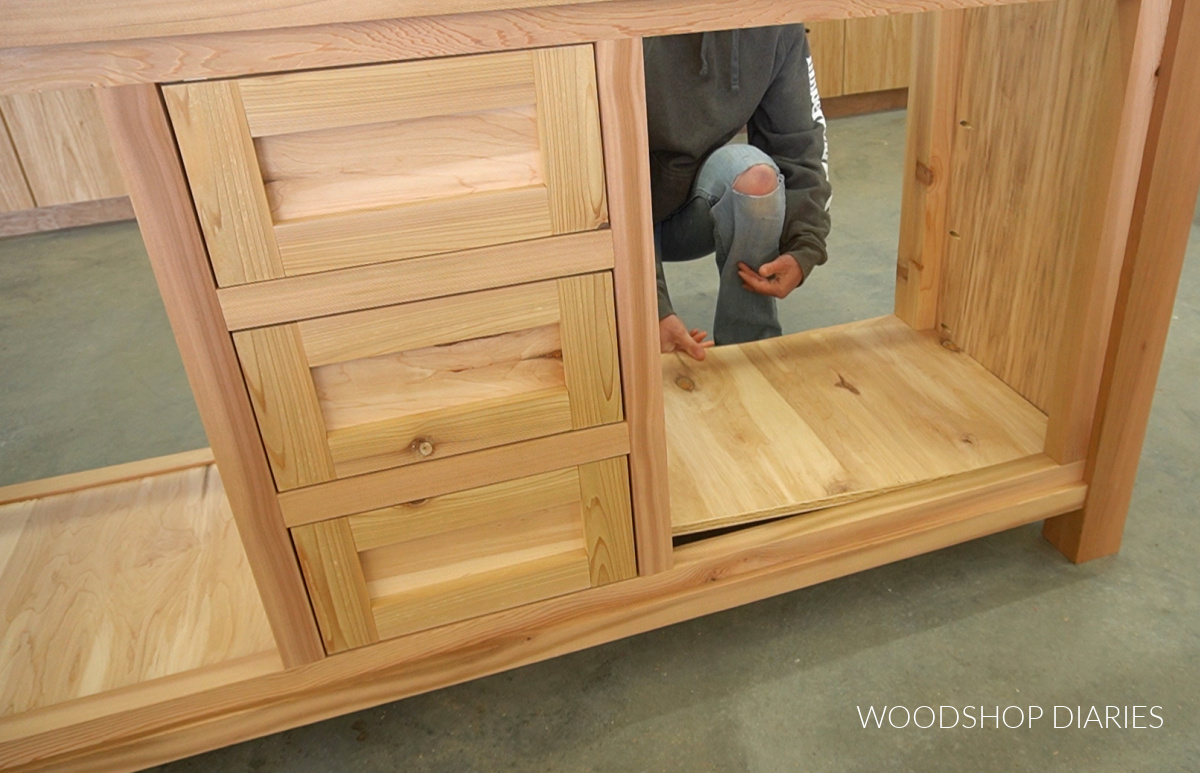 Shara Woodshop Diaries placing bottom panel into vanity cabinet