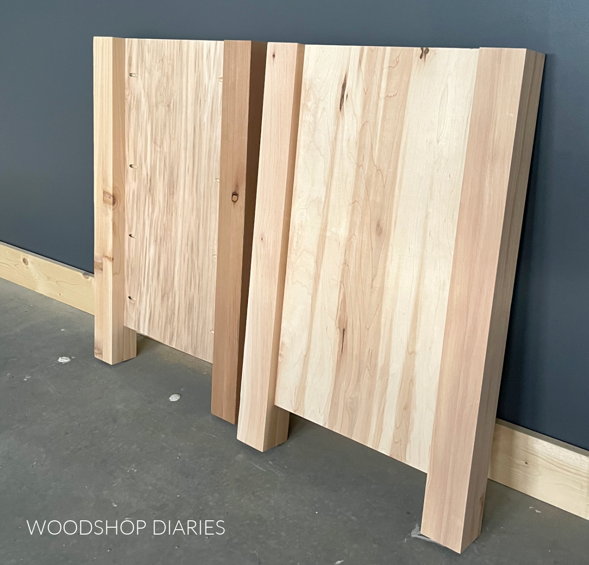 Two bathroom vanity side panels assembled leaning against wall