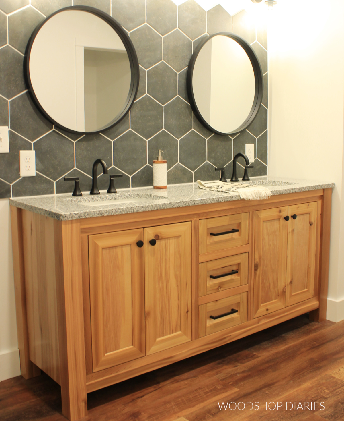 Cedar bathroom vanity with grey countertop and dark grey hexagon backsplash