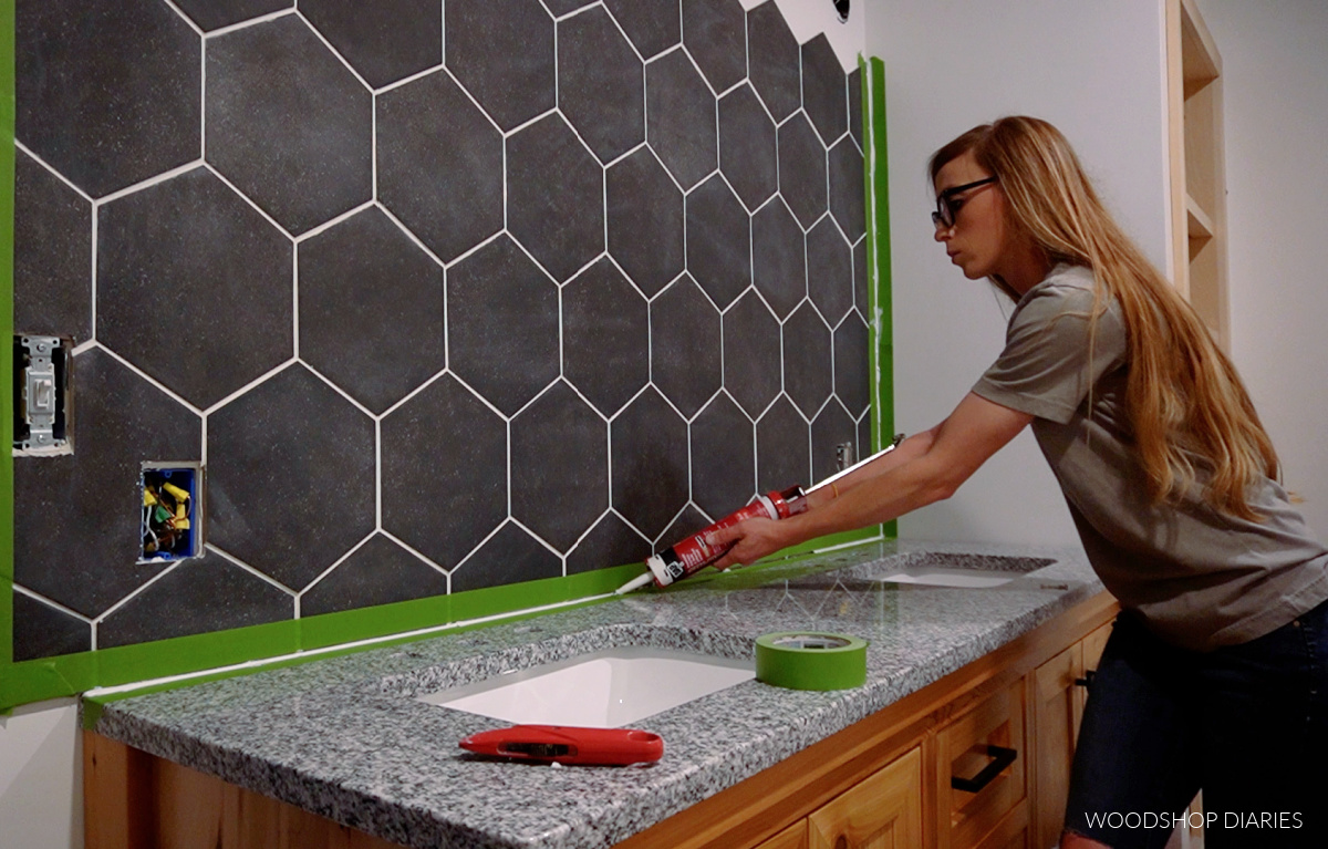 Shara Woodshop Diaries caulking between hexagon backsplash and granite countertop on bathroom vanity