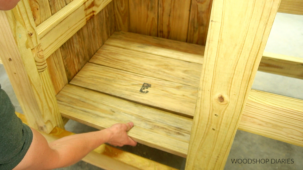 Shara Woodshop Diaries placing center cabinet bottom slats in place