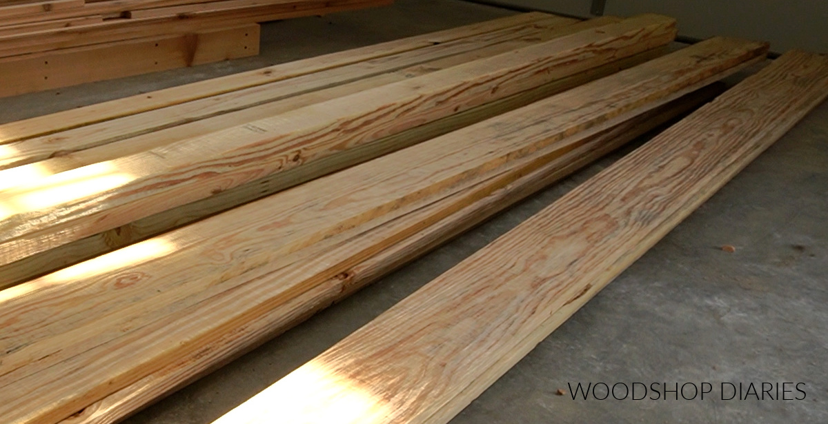 Pressure treated wood lying on concrete floor in workshop