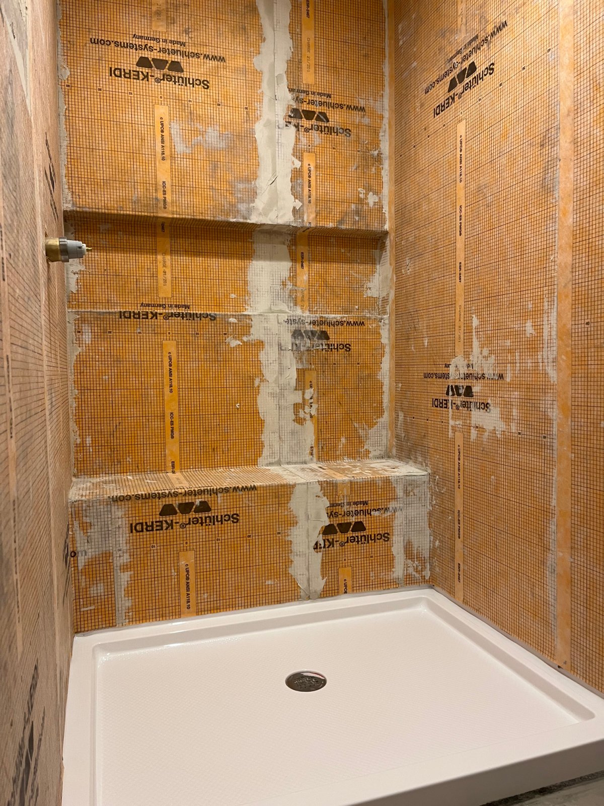 Schluter Kerdi applied to shower walls around shower pan