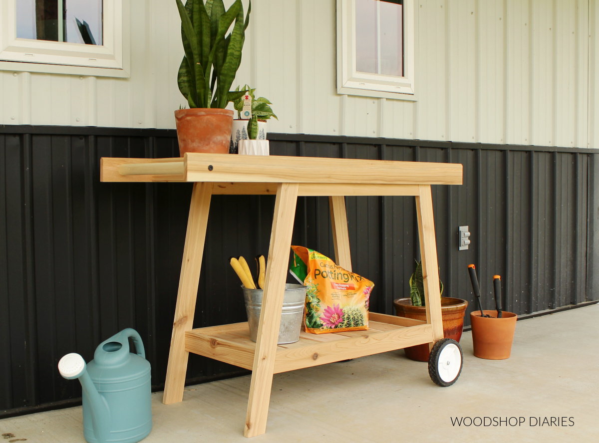 Adorable cedar potting bench cart with plastic wheels and bottom shelf